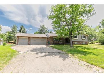 Charming single Gathering home with a brick exterior and a spacious two car garage at 13990 Berry Rd, Golden, CO 80401