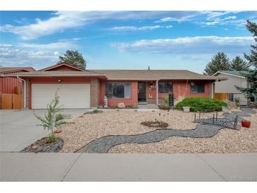 Charming single story home with a two car garage and xeriscaped front yard and walkway at 2140 S Youngfield St, Lakewood, CO 80228