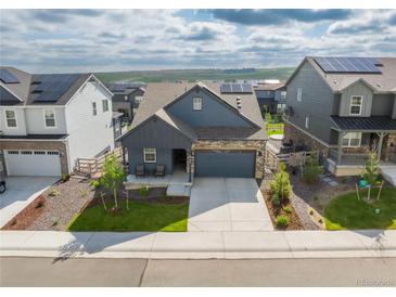 Charming single-Gathering home boasting manicured lawn, stone accents, and a two-car attached garage at 8132 Mt Harvard Rd, Littleton, CO 80125