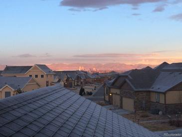 Scenic view of a neighborhood with the city skyline and mountains in the background at sunset or sunrise at 237 Dayton St, Denver, CO 80230