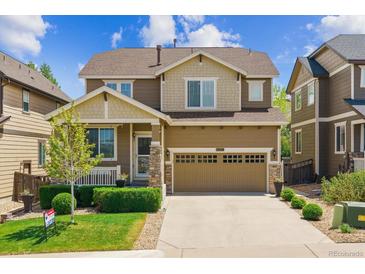 Charming two-story home features a well-manicured lawn and attached two-car garage at 2948 Open Sky Way, Castle Rock, CO 80109