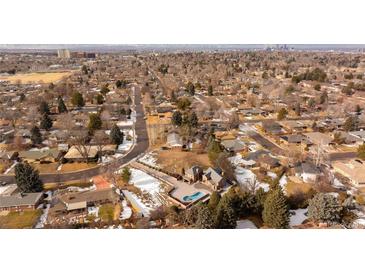 Stunning aerial view of a home with an in-ground pool nestled in a neighborhood with city views at 434 S Newport Way, Denver, CO 80224