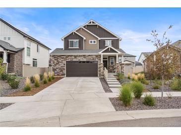 Beautiful two-story home with a stone and brown wood exterior and well-manicured front yard at 4408 Riviera Ct, Aurora, CO 80019