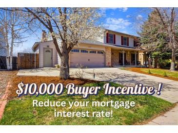 Charming two-story home featuring a two-car garage, inviting front porch and mature trees in a well-manicured yard at 1479 S Jasper St, Aurora, CO 80017