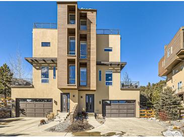 Striking contemporary home featuring a unique facade, multiple balconies, and a two-car garage at 28665 Tepees Way, Evergreen, CO 80439