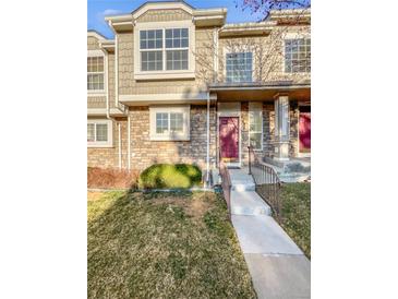 Charming townhome with a well-manicured lawn and stone facade at 1256 S Zeno Cir # E, Aurora, CO 80017