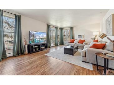 Bright living room with hardwood floors, large windows, and comfortable seating at 320 S Ames St # 8, Lakewood, CO 80226