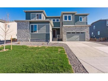 Two-story home with stone accents and a landscaped lawn at 1714 Marlowe W Cir, Erie, CO 80516