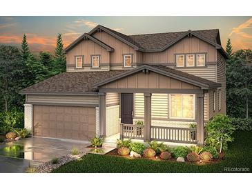 Charming two-story home featuring a covered porch, attached garage, and well-maintained landscaping at 243 Marlowe Dr, Erie, CO 80516