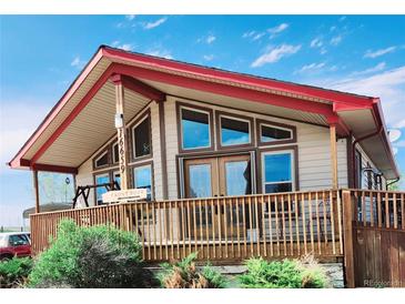 Charming home featuring a spacious front porch, complemented by large windows offering plenty of natural light at 16659 County Road 4, Brighton, CO 80603