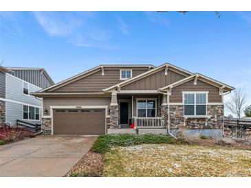 Charming single-Gathering home featuring stone accents, a covered porch, and an attached two-car garage at 24608 E Moraine Pl, Aurora, CO 80016