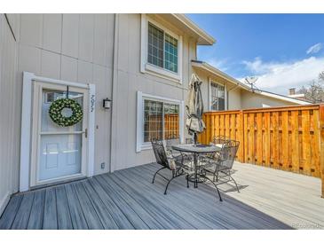 Charming back deck, perfect for outdoor dining and relaxation with patio furniture at 7077 S Knolls Way, Centennial, CO 80122