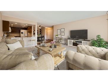 Comfortable living room featuring neutral tones and an open floor plan to kitchen, perfect for modern living at 13961 E Marina Dr # 205, Aurora, CO 80014