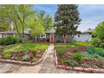 Charming single-story home with a landscaped front yard and a welcoming red front door at 1343 Gay St, Longmont, CO 80501