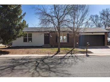 A single-Gathering home showing the front exterior with brick and white siding at 1266 S Telluride St, Aurora, CO 80017