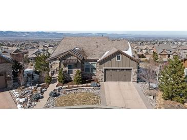 Charming home featuring a well-manicured front yard, attached two-car garage, and classic architecture at 10640 Winding Pine Pt, Highlands Ranch, CO 80126