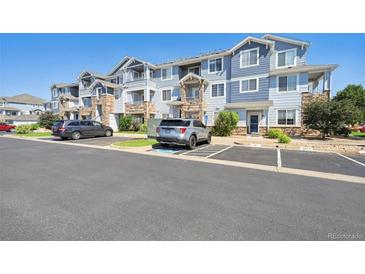 Three-story apartment building with parking and landscaping at 5255 Memphis St # 207, Denver, CO 80239