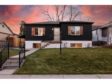 Charming home with a dark exterior, white base, and complemented by striking wood window shutters at 4565 Elm Ct, Denver, CO 80211