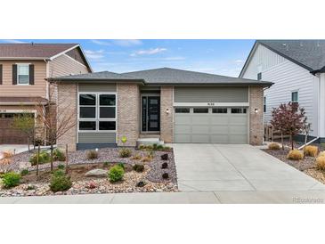 Charming single Gathering home with a beautifully landscaped front yard and attached two-car garage at 9130 Fraser River, Littleton, CO 80125