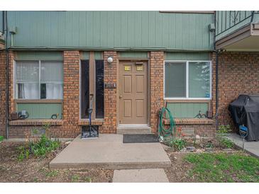 Inviting brick front entrance featuring a well maintained garden and visible address at 8870 W Jewell Ave # 11, Lakewood, CO 80232