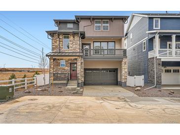A stylish two-story home with a stone facade and a spacious two-car garage, modern design at 2090 S Haleyville Way, Aurora, CO 80018