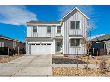 Charming two-story home with a two-car garage and a well-maintained front yard landscape with decorative rock at 131 S Vandriver Way, Aurora, CO 80018