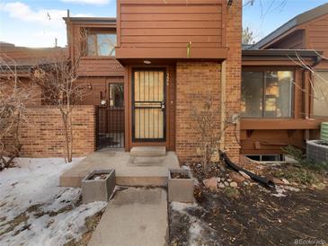 Exterior view of townhome with brick and wood siding at 2685 S Dayton Way # 326, Denver, CO 80231