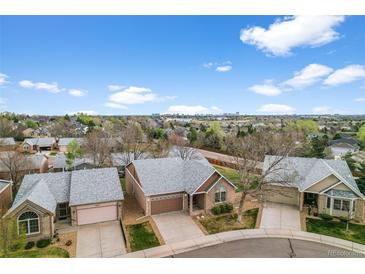 Inviting brick home with a well-maintained front yard and attached two-car garage, set in a desirable neighborhood at 4927 Greenwich Way, Highlands Ranch, CO 80130