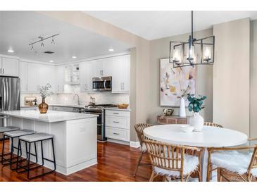 Bright eat-in kitchen with a large island and modern stainless steel appliances at 1631 N Emerson St # 117, Denver, CO 80218