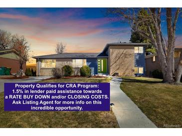 Charming single-Gathering home featuring a well-maintained lawn and a welcoming green front door at 10699 W 9Th Pl, Lakewood, CO 80215