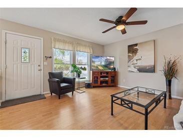 Inviting living room featuring modern furniture, wood floors, and natural light at 9901 E Evans Ave # 9A, Aurora, CO 80247