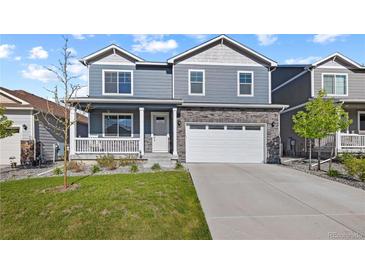 Charming two-story home with a well-maintained front lawn and covered porch at 2144 Rosette Ln, Castle Rock, CO 80104