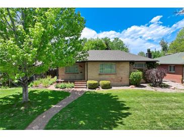 Charming brick home with mature tree, lush lawn, and quaint brick walkway at 3245 S High St, Englewood, CO 80113