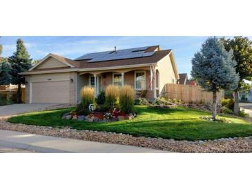 Charming single-story home featuring a well-maintained front yard with lush grass and mature landscaping at 2190 S Uravan St, Aurora, CO 80013