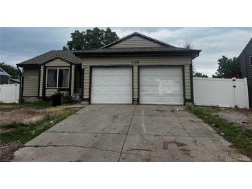 Charming single-story home with a two-car garage and a well-maintained front yard at 5129 Chandler Way, Denver, CO 80239