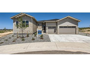 New construction home featuring a two-car garage and a stone-accented facade at 366 Agoseris Way, Castle Rock, CO 80104
