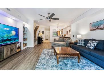 Cozy living room features a modern ceiling fan, comfortable seating, and hardwood flooring at 7250 Eastmoor Dr # 122, Denver, CO 80237