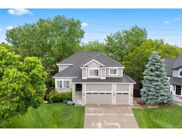 Charming two-story home with a three-car garage, brick accents, and a well-manicured lawn at 9871 Indian Wells Dr, Lone Tree, CO 80124