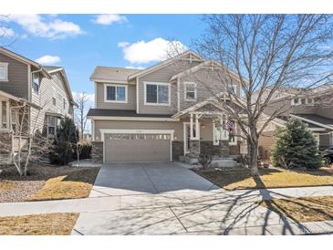 Beautiful two-story home with manicured lawn and spacious driveway at 16404 E 117Th Ave, Commerce City, CO 80022