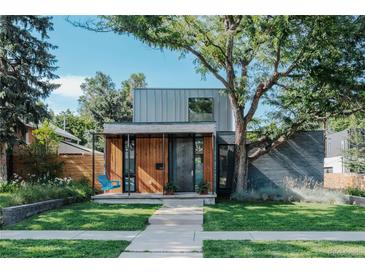 Striking modern home with unique architectural details, mature trees, and inviting front porch at 2627 W 40Th Ave, Denver, CO 80211