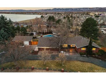 Property aerial view, showing a lake view and multiple buildings on an oversized lot at 7382 W Stanford Ave, Littleton, CO 80123