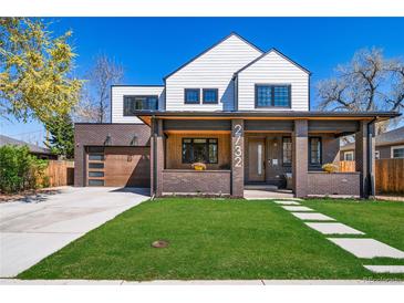 Charming two-story home with white siding, brick accents, covered porch, and well-maintained lawn at 2732 S Jackson St, Denver, CO 80210
