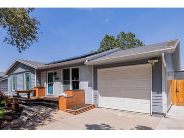 Charming single Gathering home with attached garage, landscaped yard, and solar panels on the roof at 2452 S Norfolk St, Aurora, CO 80013