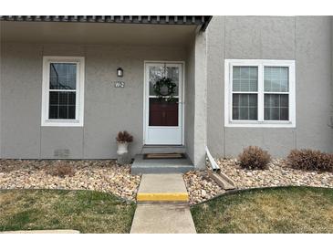 Charming entryway with wreath-adorned door, stone landscaping, and visible unit number at 2301 E Fremont Ave # W02, Centennial, CO 80122