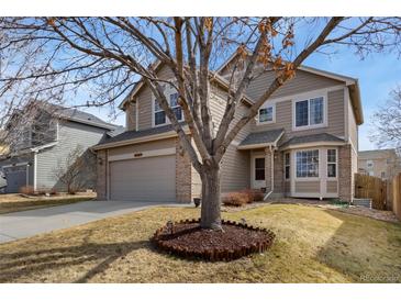 Charming two-story home features a well-maintained front yard and attached two-car garage at 6280 Snowberry Ave, Firestone, CO 80504