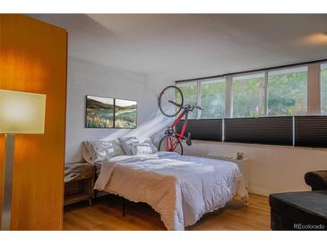 Bright bedroom with double bed, large windows, and bike storage at 1196 N Grant St # 113, Denver, CO 80203