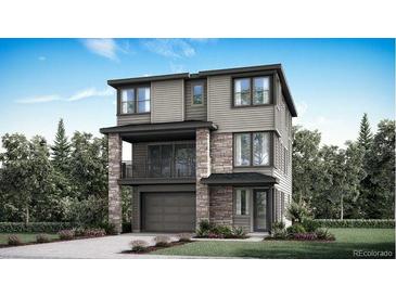 A modern, three-story home features stone accents, a balcony, and a two-car garage at 3179 S Russell St, Morrison, CO 80465