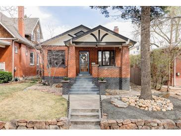 Charming brick home with inviting front porch and professionally landscaped front yard at 680 S Ogden St, Denver, CO 80209