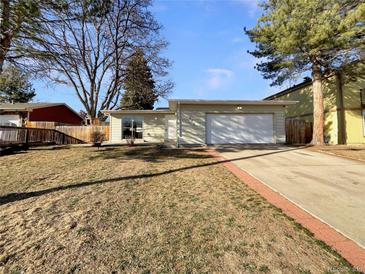 Charming single-story home with an attached two-car garage and well-manicured front yard at 927 E 7Th Ave, Broomfield, CO 80020