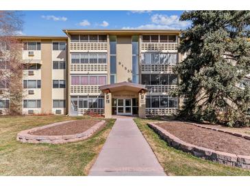 Tan condominium building with well-maintained landscaping and inviting entrance at 9155 E Center Ave at 9155 E Center Ave # 3C, Denver, CO 80247